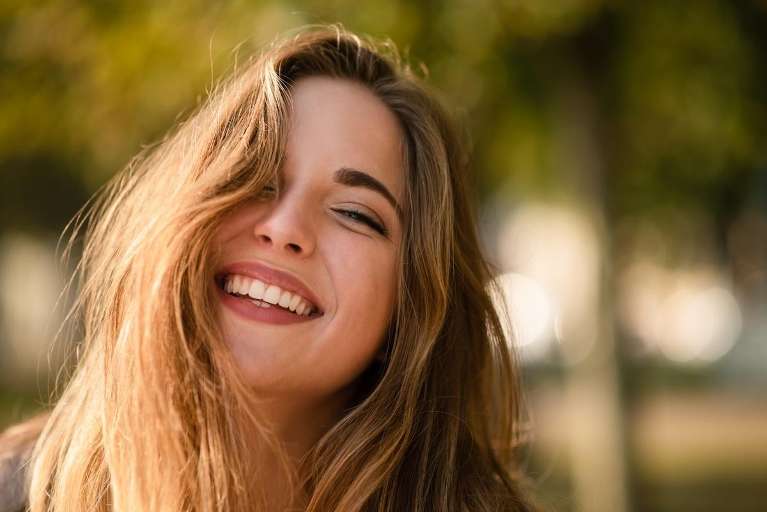 A woman smiling after getting Dental Implants in Apex, NC